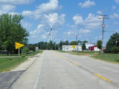 View down street with wind turbines